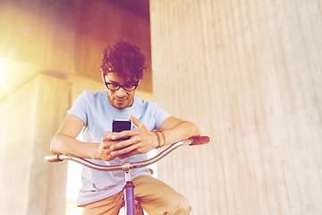 Image showing man with smartphone and fixed gear bike on street