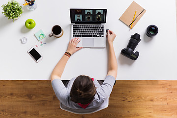 Image showing woman with camera flash drive and laptop at table