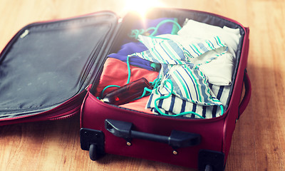 Image showing close up of travel bag with beach clothes