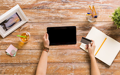 Image showing hands with tablet pc and credit card at table