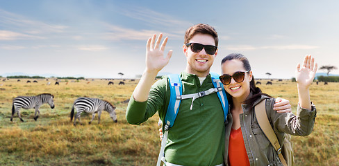 Image showing smiling couple with backpacks traveling in africa