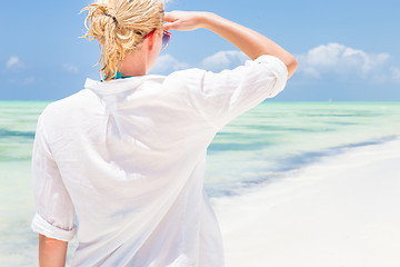 Image showing Happy woman enjoying, relaxing joyfully in summer on tropical beach.