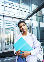 Image showing young cute indian girl at university building sitting on stairs 