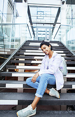 Image showing young cute indian girl at university building sitting on stairs 