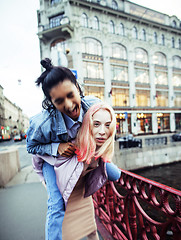 Image showing Two teenage girls infront of university building smiling, having