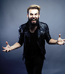 Image showing portrait of young bearded hipster guy on gray dark background close up, brutal modern man, lifestyle people concept 