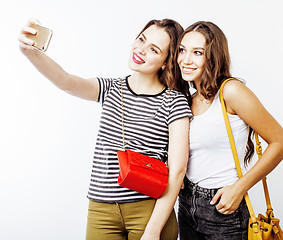 Image showing best friends teenage girls together having fun, posing emotional on white background, besties happy smiling, lifestyle people concept close up. making selfie