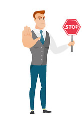 Image showing Caucasian businessman holding stop road sign.