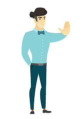 Image showing Asian businessman showing stop hand gesture.