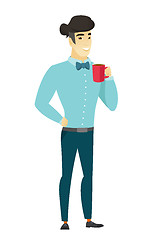 Image showing Young asian businessman holding cup of coffee.