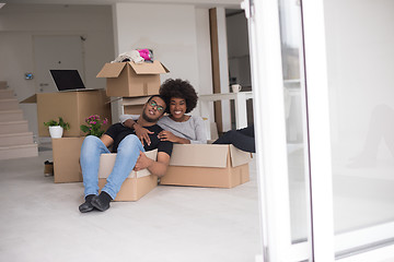 Image showing African American couple  playing with packing material