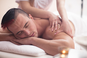 Image showing young man having a back massage