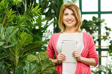 Image showing Florist holding tablet in shop