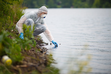 Image showing Biologist with bulb on river