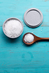 Image showing sea salt in bowl and in spoon on wooden background