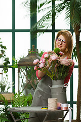 Image showing Woman with apron with flowers