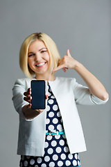 Image showing Woman with phone showing shaka