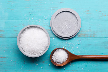 Image showing sea salt in bowl and in spoon on wooden background