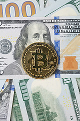 Image showing Photo of dollars with golden bitcoin