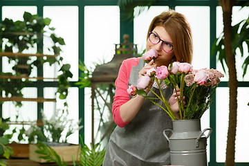 Image showing Florist in glasses with flowers