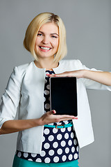 Image showing Smiling young girl holding tablet