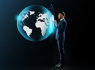 Image showing businessman in suit with virtual earth projection