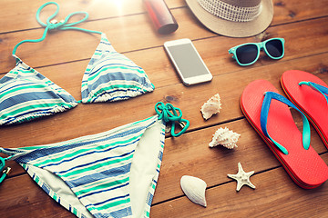 Image showing close up of smartphone and beach stuff