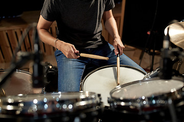 Image showing man playing drums at concert or music studio