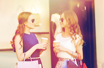 Image showing young women with shopping bags and coffee at shop