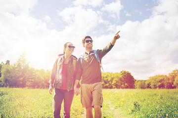 Image showing happy couple with backpacks hiking outdoors