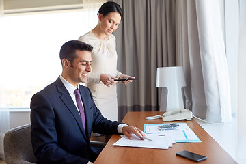 Image showing business team with papers working at hotel room