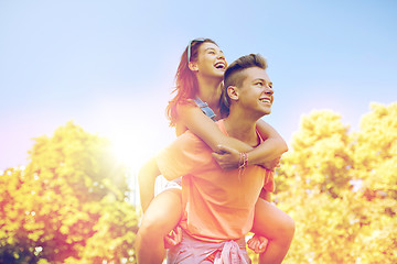 Image showing happy teenage couple having fun at summer park