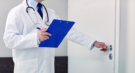 Image showing close up of doctor with clipboard at hospital door