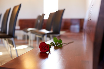 Image showing red roses on bench at funeral in church