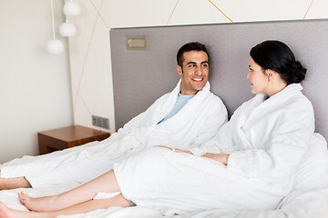 Image showing happy couple in bed at home or hotel room