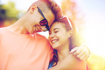 Image showing happy teenage couple hugging at summer