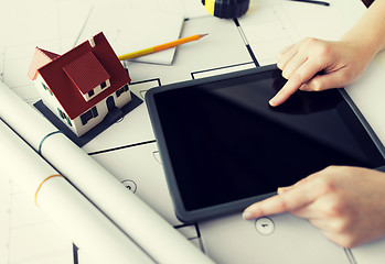 Image showing close up of hand with blueprint and tablet pc