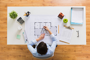 Image showing architect with compass measuring blueprint