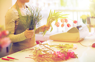 Image showing close up of florist making bunch at flower shop