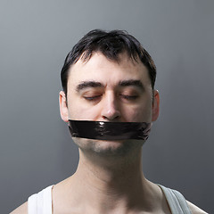 Image showing man with duck tape on face