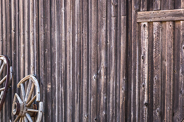 Image showing Abstract of Vintage Antique Log Cabin Wall and Wagon Wheel.