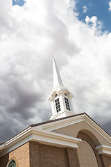 Image showing Church Steeple Tower Below Ominous Stormy Thunderstorm Clouds.