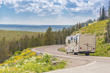 Image showing Camper Driving Down Road in The Beautiful Countryside Among Pine