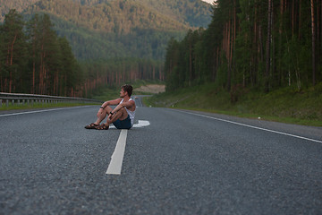 Image showing Man sitting on the road