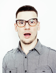 Image showing young handsome teenage hipster guy posing emotional, happy smiling against white background isolated, lifestyle people concept 