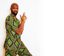 Image showing portrait of young handsome african man wearing bright green national costume smiling gesturing, entertainment stuff 