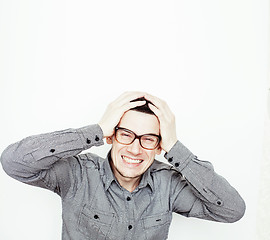 Image showing young handsome teenage hipster guy posing emotional, happy smiling against white background isolated, lifestyle people concept 