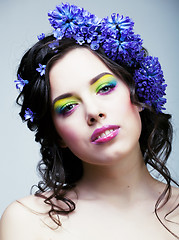 Image showing Beauty young woman with flowers and make up close up, real sprin