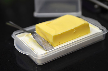 Image showing Butter cube on the black table 