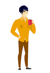 Image showing Young asian businessman holding cup of coffee.